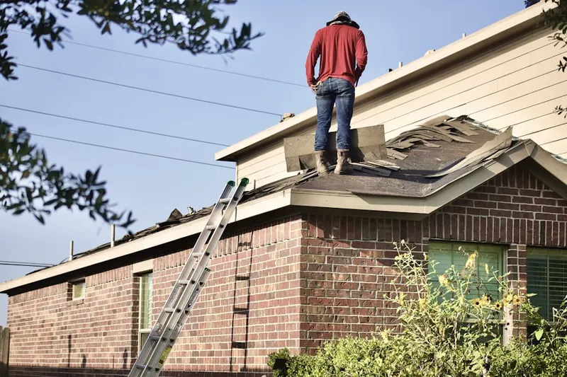 Professional roofer working on a residential roof in Rosemont
